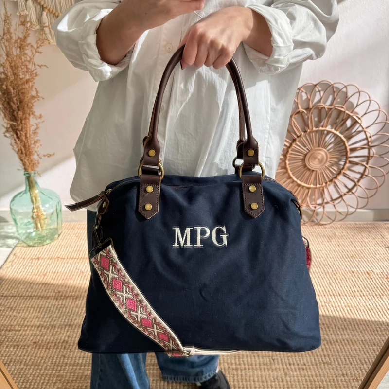 Bolso combinado loneta y piel azul marino iniciales bordadas con correa étnica