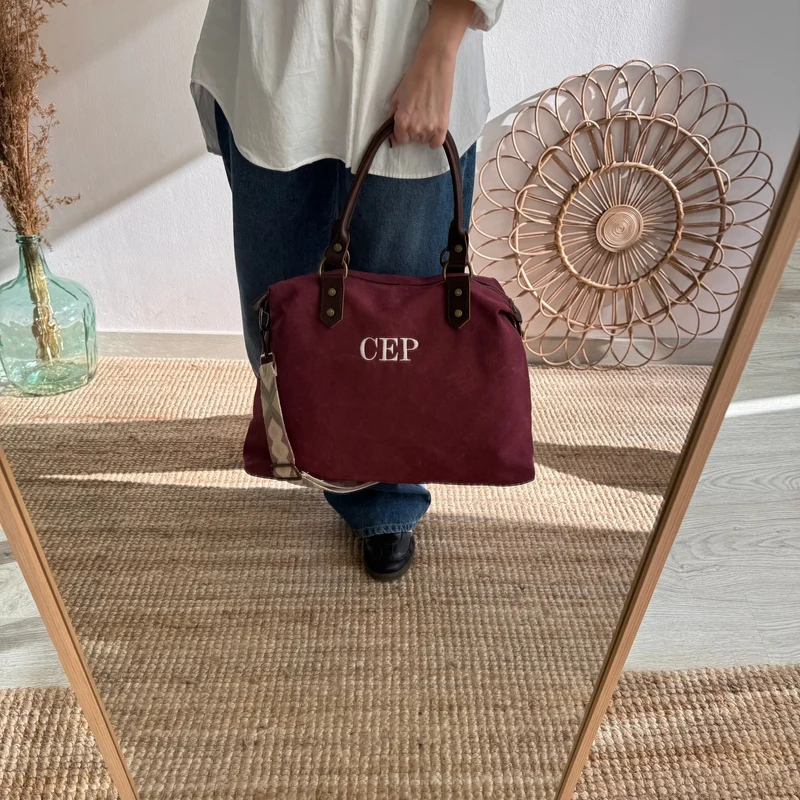 Bolso combinado loneta y piel granate iniciales bordadas con correa étnica