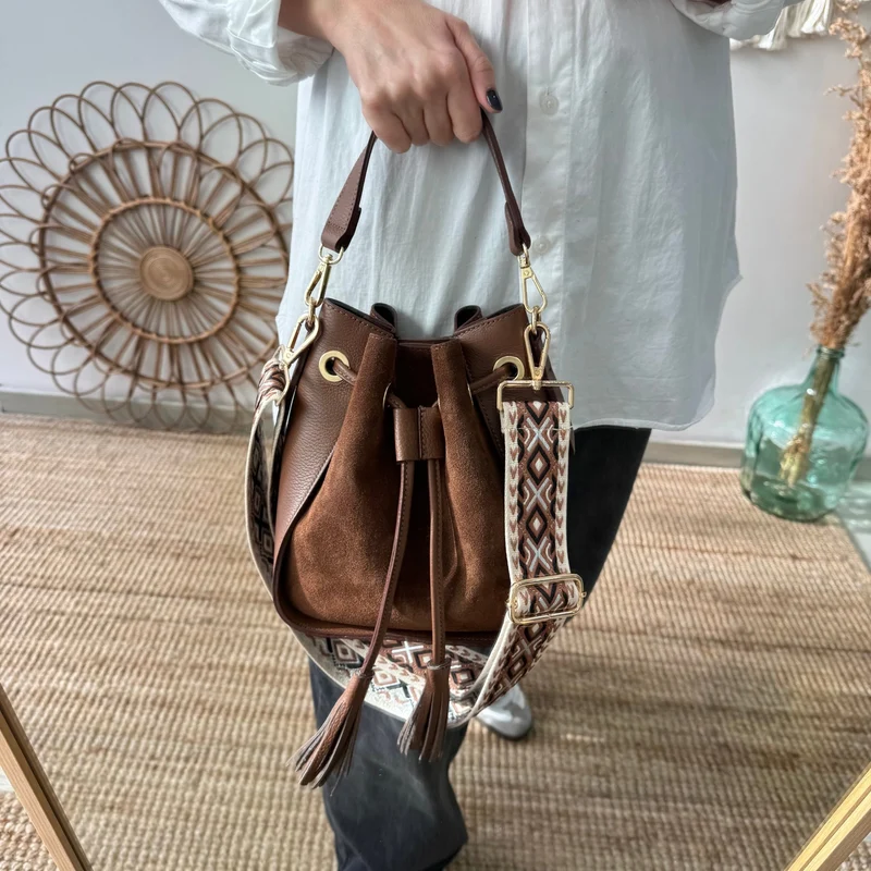 Bolso bucket combinado serraje y piel marrón pompón iniciales bordadas