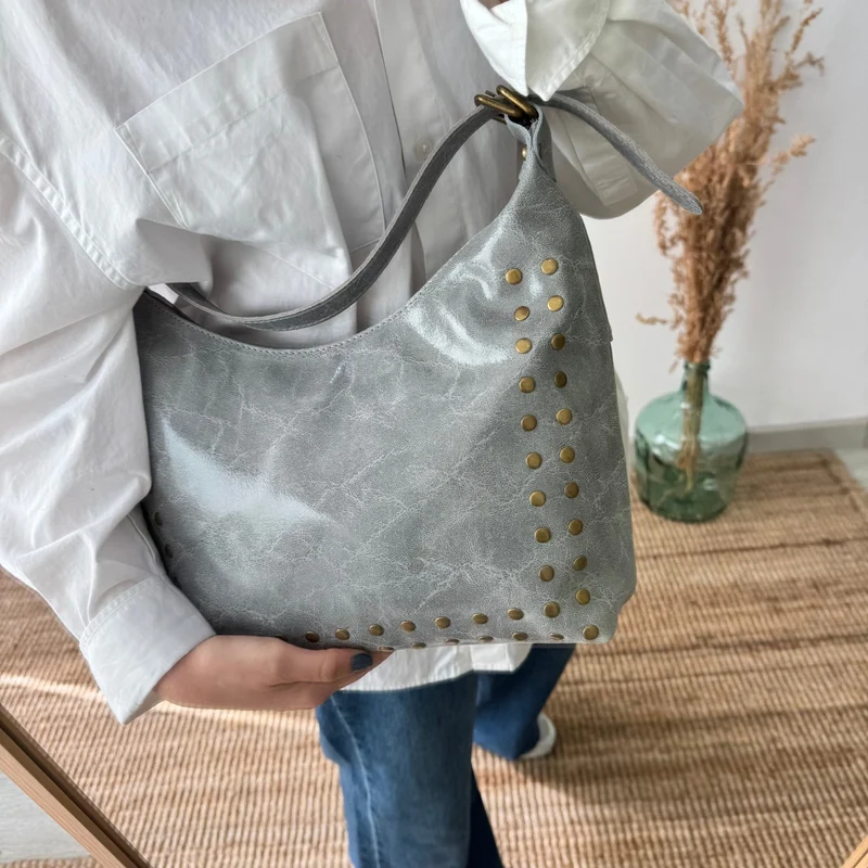 Bolso tachuelas piel gris claro iniciales bordadas